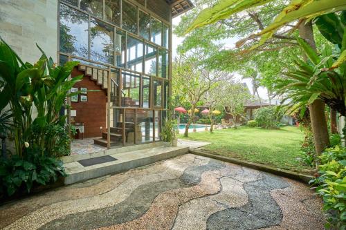 a house with a stone path in front of a building at Casa Ola Villa Pererenan in Canggu