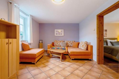 a living room with a couch and a table at Pension Schmidt in Bad Brambach