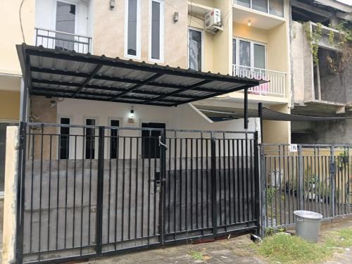 a black iron gate with a black canopy in front of a house at Private Villa Near Nusa Dua Beach Bali in Nusa Dua