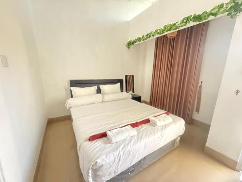 a bedroom with a large bed with towels on it at Private Villa Near Nusa Dua Beach Bali in Nusa Dua