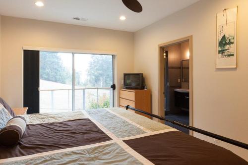 a bedroom with a bed and a large window at Mountain House in Mount Hood