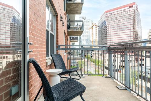 two chairs on a balcony with a view of the city at Kasa Downtown Austin in Austin