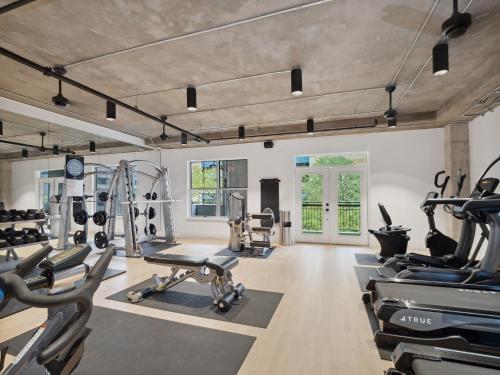 a gym with a lot of treadmills and machines at Kasa Downtown Austin in Austin