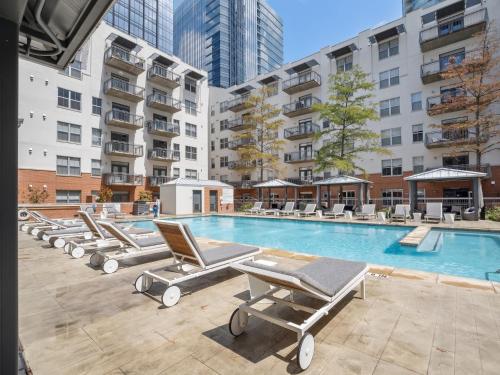 a swimming pool with lounge chairs in a building at Kasa Downtown Austin in Austin