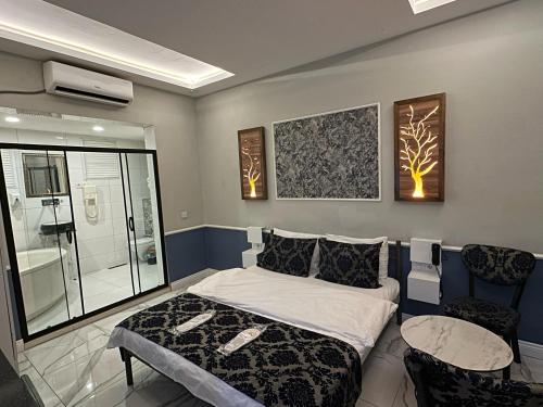a bedroom with a bed and a glass shower at Bakırköy Otel in Istanbul
