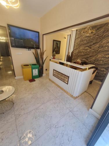 a living room with a large tv and a tub at Bakırköy Otel in Istanbul