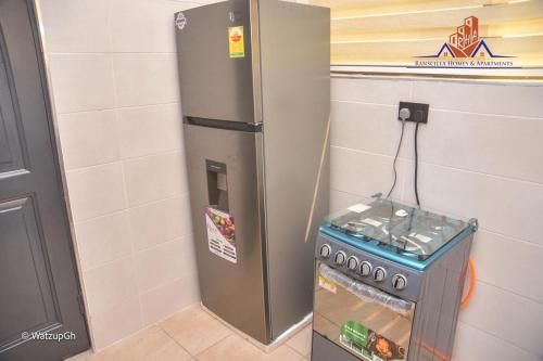 a refrigerator with a drink inside of it at Ranscilla Homes & Apartments in Tema