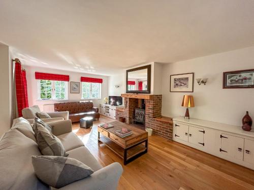 a living room with a couch and a fireplace at The Cottage - Uk50673 in Tangmere