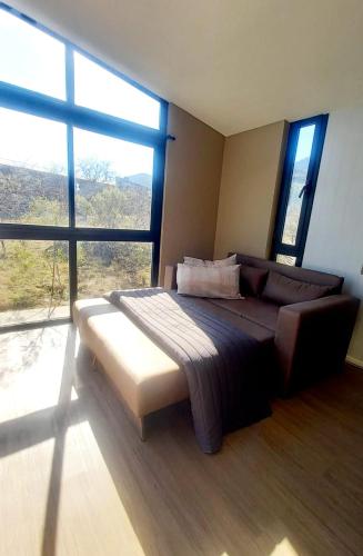 a bedroom with a large bed and a large window at Cubos habitables 3 in San Antonio de Arredondo