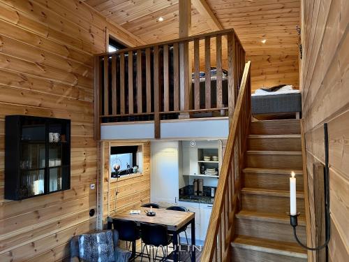 a wooden cabin with a table and a staircase at Lindvallen Ski Resort - Studio - 4 Guests in Sälen