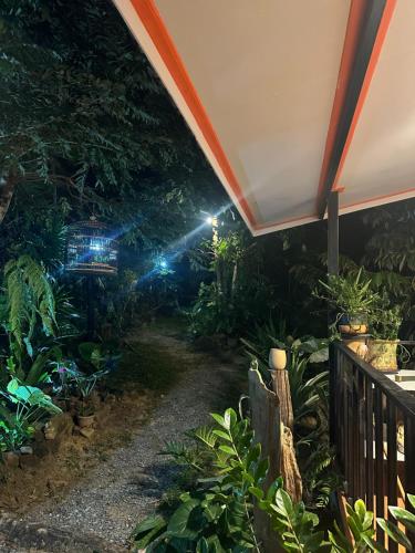 a garden at night with a flashlight at Chalee Guest House in Ban Khlong Mat