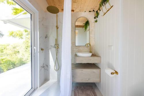 A bathroom at Rainforest Retreat YIN Tiny Home with Ocean Views