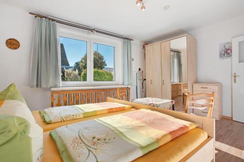 a bedroom with two beds and a window at Haus Frieda in Ostseebad Koserow