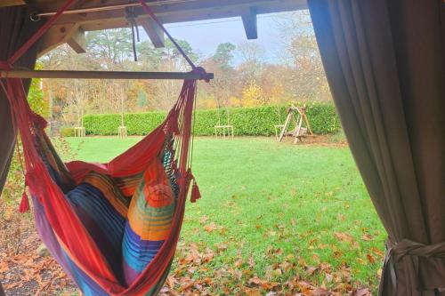a hammock hanging in a yard with a playground at Ravensdale Retreat Dundalk in Dundalk