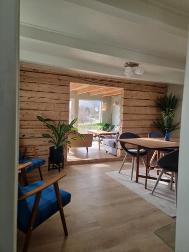 a living room with wooden walls and a table and chairs at Nordhaven Retreat- Lofoten in Vestvågøya