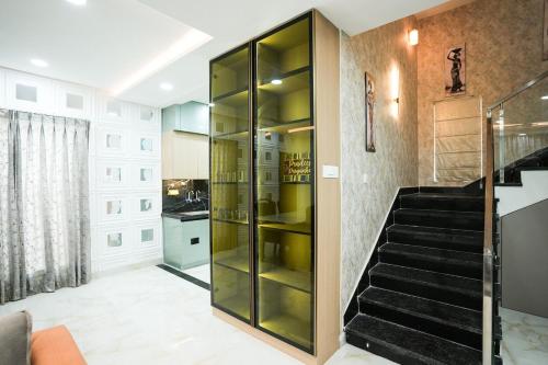 a glass cabinet in a hallway with a staircase at Hangout Ville in Hyderabad