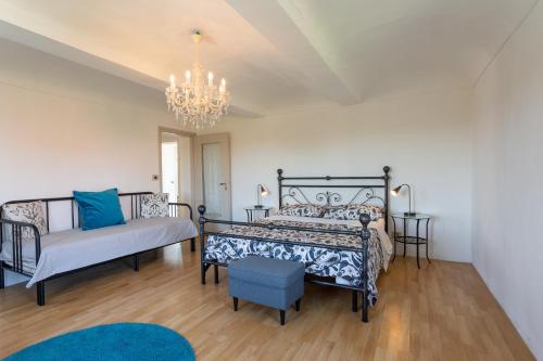 a bedroom with two beds and a chandelier at La Dolcevita in Mombercelli