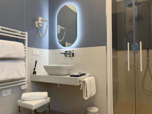a bathroom with a sink and a mirror at Soleblu Guesthouse in Albissola Marina