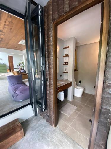 a bathroom with a glass door leading to a bedroom at Kalamari Luxury Beach Front Villa in Mae Nam