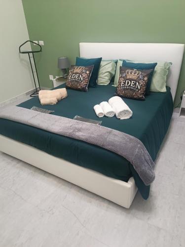 a bed with pillows and towels on it at Eden Borbonico in Caserta
