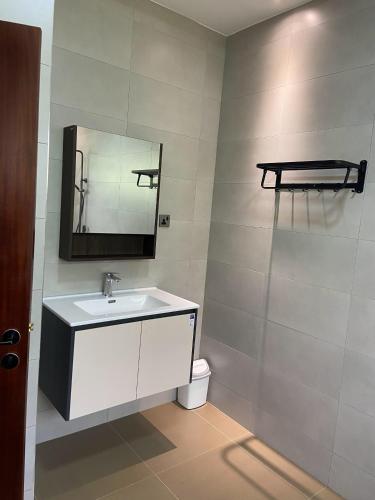 a bathroom with a sink and a mirror and a toilet at The Villa Residences Katale in Kansiri