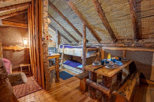 a room with a table and two bunk beds at Camping Alsace Les Castors in Burnhaupt-le-Haut
