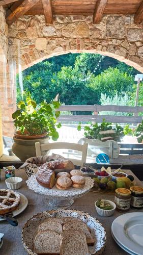 a table topped with lots of different types of bread at Agriturismo Tuluschene in Gavoi