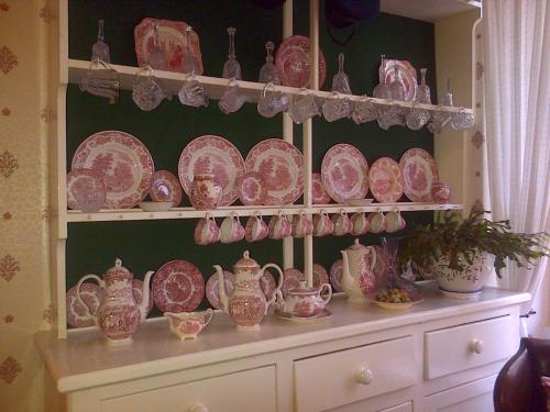a bunch of plates and bowls on a shelf at Lewinsdale Lodge in Weston-super-Mare