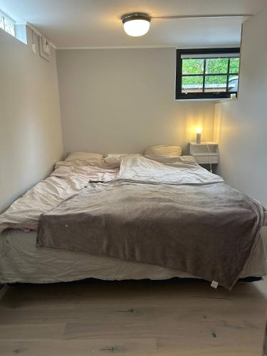 a large bed in a bedroom with a window at Apartment in beautiful area Edsviken, close to Stockholm in Sollentuna