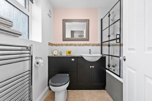 un baño con inodoro y lavabo en Near Warwick Hospital, Cozy Studio, Free Parking, en Warwick