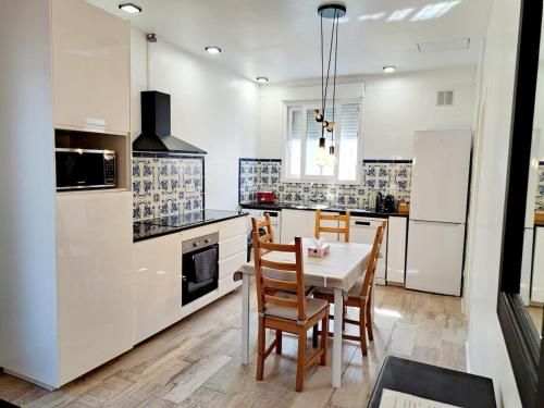 a kitchen with a table and chairs in a room at Casa Villami, GROUND FLOOR APARTMENT in Marchuquera