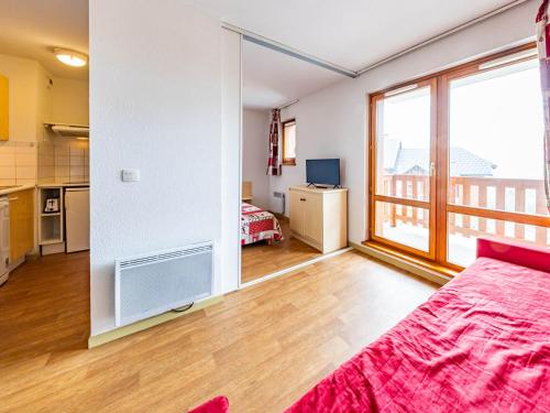 a room with a bed and a large window at Appartement 6 pers, pieds des pistes, St-François-Longchamp - FR-1-807-105 in Saint-François-Longchamp