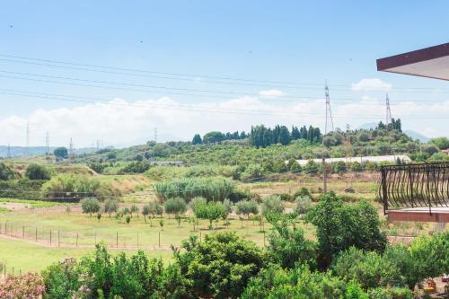 a view of a field with trees and bushes at B&B Via Nazionale in Milazzo