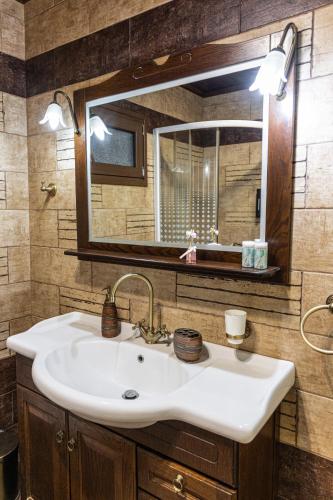 a bathroom with a sink and a mirror at illia in Maronia