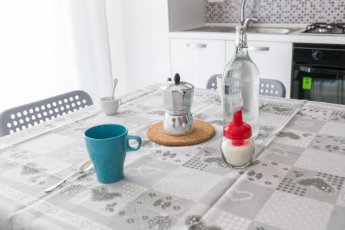 a table with a table cloth with a bottle on it at B&B Via Nazionale in Milazzo