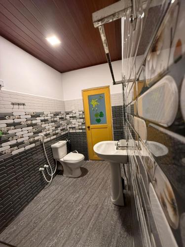 a bathroom with a toilet and a sink at Sigiri Sky Home & TreeHouse in Sigiriya