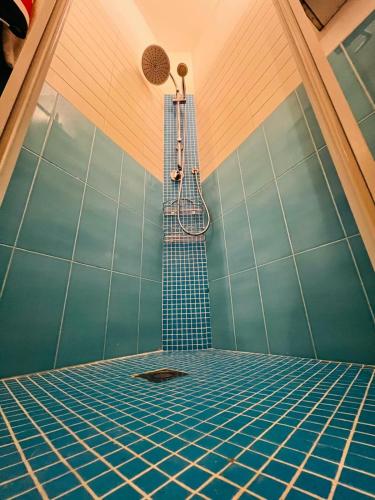 a shower in a room with blue tiles at Searoom in Lido delle Nazioni