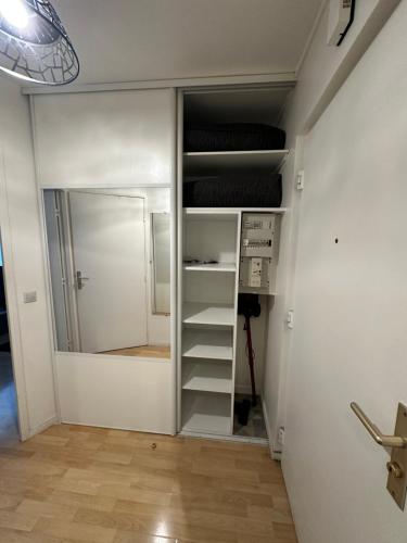 a room with a closet with a bed in it at Charmant studio à Paris in Courbevoie