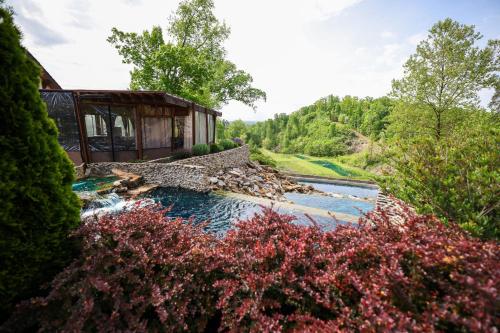 a building next to a river with flowers at Ancient Lore Village in Knoxville