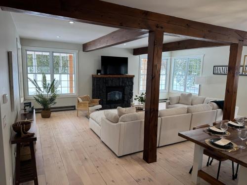a living room with two white couches and a fireplace at The Hampton House Luxury Rental in Southampton