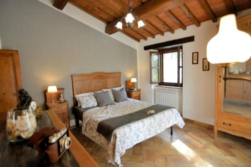 a bedroom with a bed and a table and a window at Historic Farmhouse In The Tuscan Hills in Caprese Michelangelo