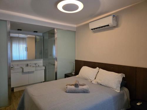 a bedroom with a bed with a towel on it at FLAT de luxo mobiliado na Savassi in Belo Horizonte