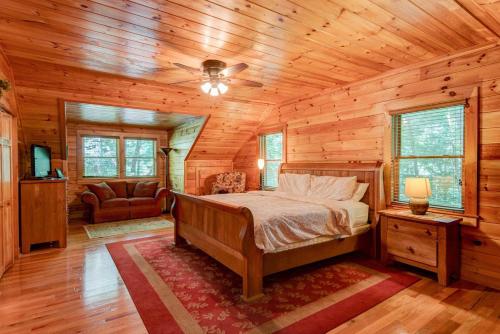 a bedroom with a bed in a wooden cabin at Little Creek Lodge in Vilas