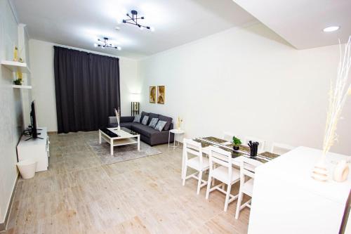 a living room with a couch and a table at Fully Furnished Brand new 1BHK at Warsan in Dubai
