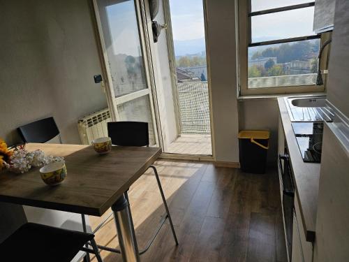 a kitchen with a table and a large window at vittorino in Turin