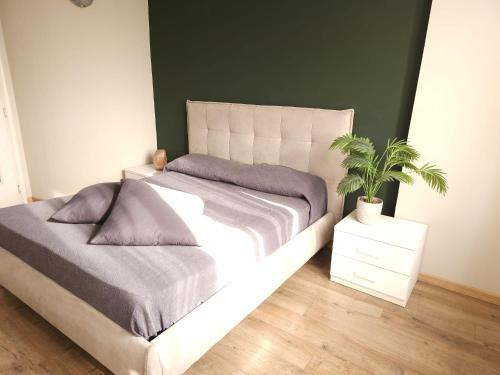 a bedroom with a bed and a potted plant at vittorino in Turin