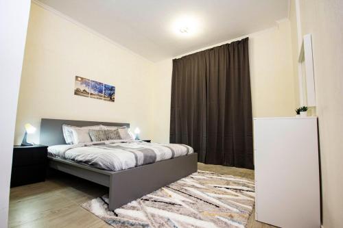a bedroom with a bed and a large window at Fully Furnished Brand new 1BHK at Warsan in Dubai