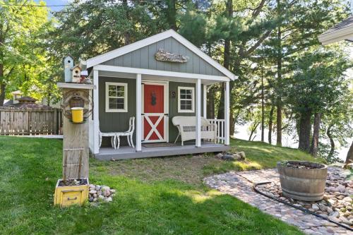 a small play house with a chair in a yard at Northbound Stays on Whitefish Lake in Vineland