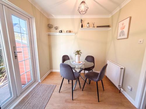 a dining room with a table and chairs and a window at Inverness Holiday Retreat - 2 Bedroom in Inverness