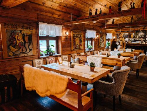 a restaurant with wooden walls and tables and chairs at Karczma Rzym Bydgoszcz S5 in Bydgoszcz